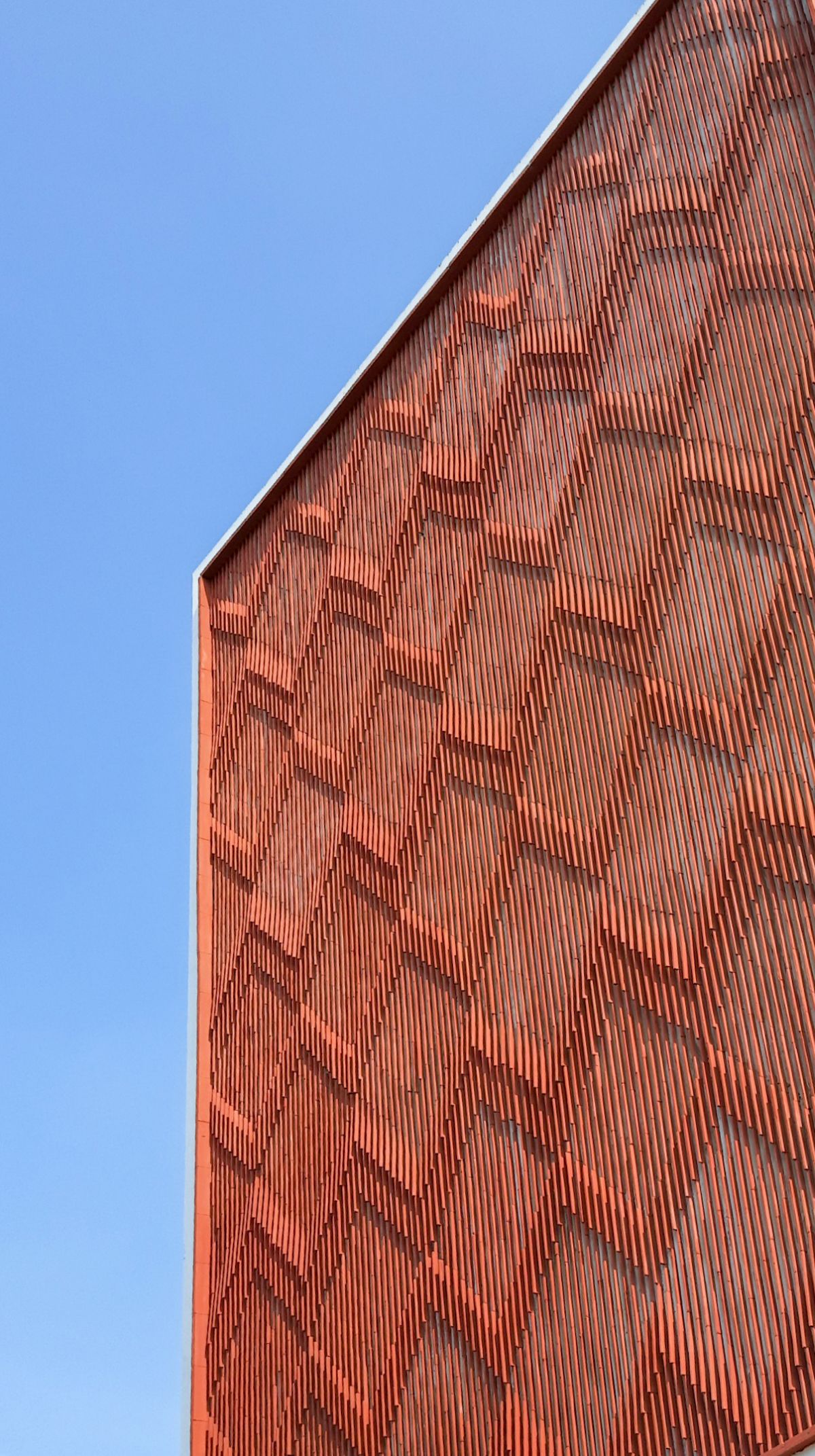 Clay roof tiles façade to minimize heat gain and has decorative function, at Vadodara, by Manoj Patel Design Studio 73