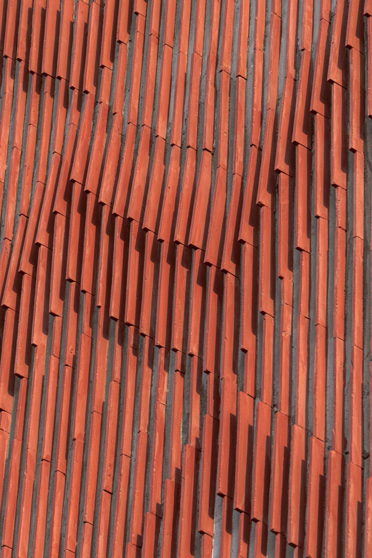 Clay roof tiles façade to minimize heat gain and has decorative function, at Vadodara, by Manoj Patel Design Studio 63