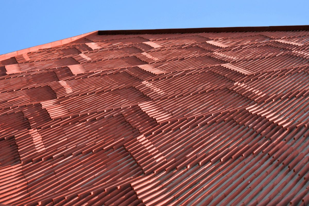 Clay roof tiles façade to minimize heat gain and has decorative function, at Vadodara, by Manoj Patel Design Studio 97