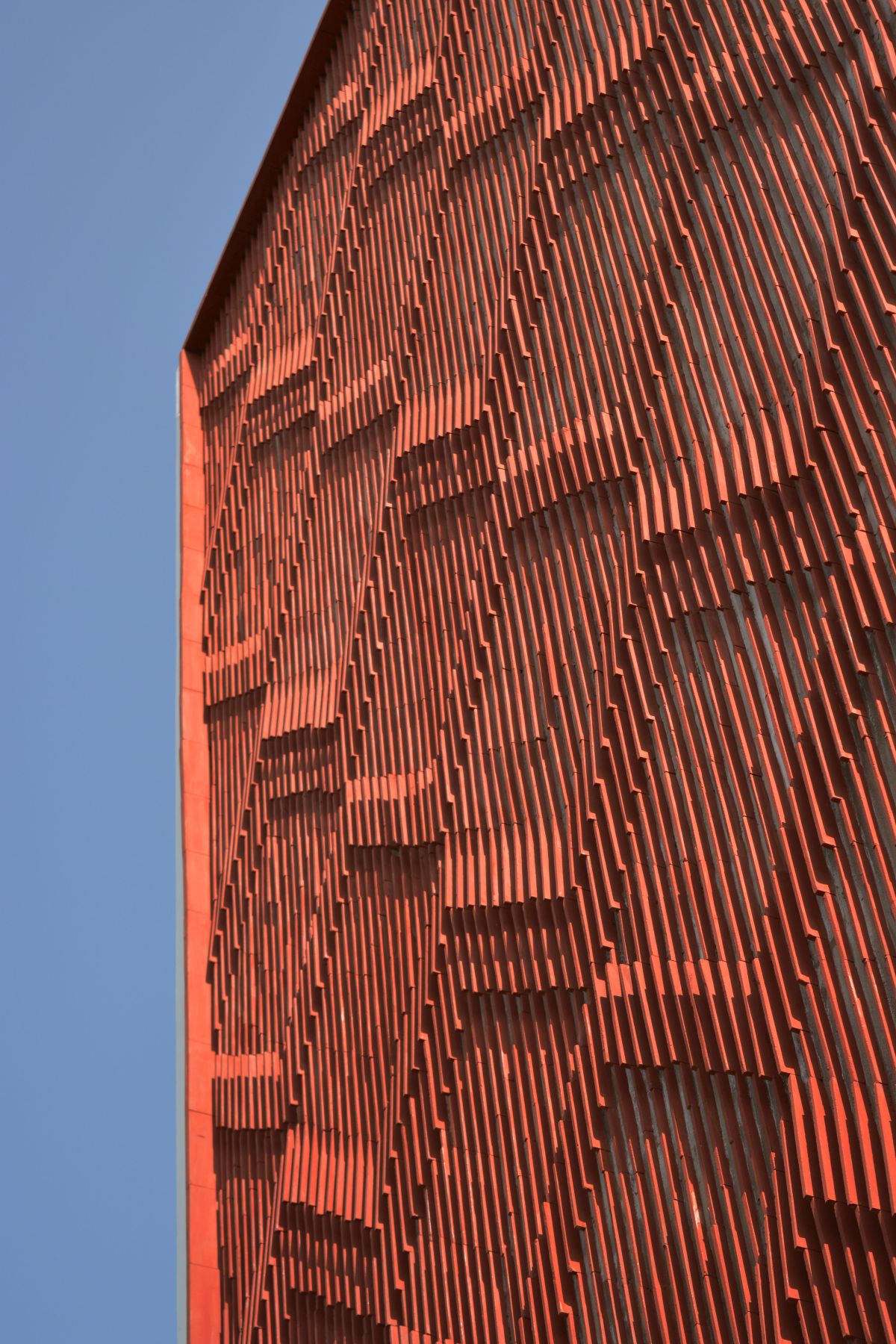 Clay roof tiles façade to minimize heat gain and has decorative function, at Vadodara, by Manoj Patel Design Studio 71