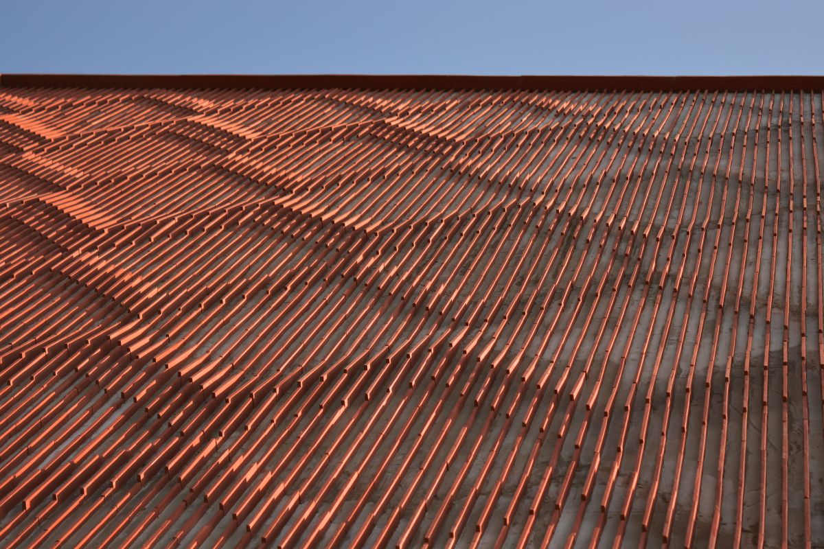 Clay roof tiles façade to minimize heat gain and has decorative function, at Vadodara, by Manoj Patel Design Studio 91