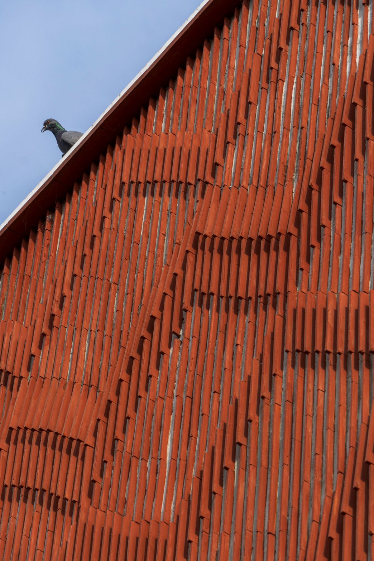 Clay roof tiles façade to minimize heat gain and has decorative function, at Vadodara, by Manoj Patel Design Studio 69