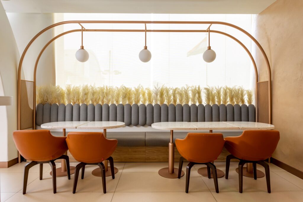 Copper coloured elements and curvilinear tabled setting at UNCAFE, New Delhi, by TI:DO. Photograph by Jeetin Sharma 